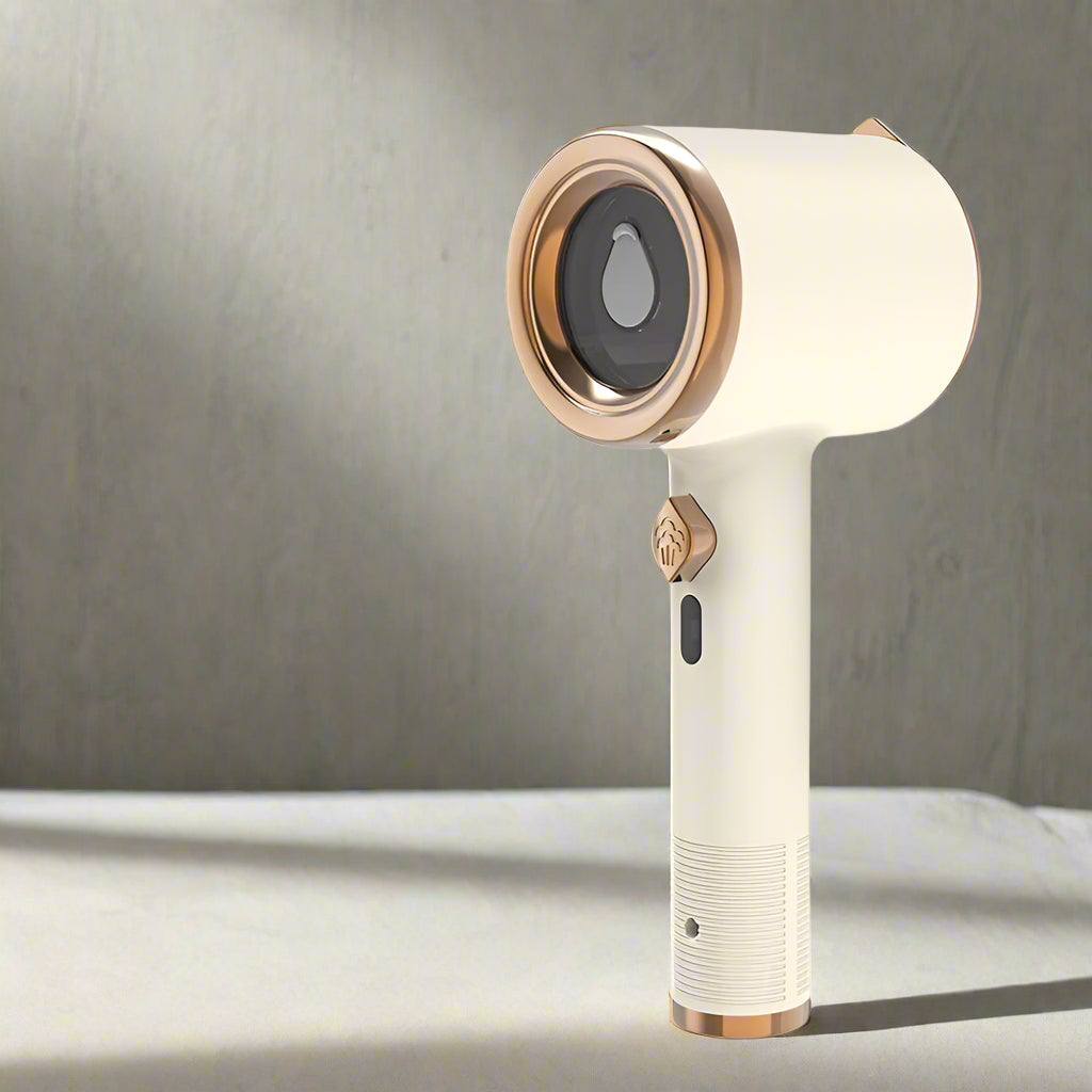 White and rose gold handheld device on a gray background